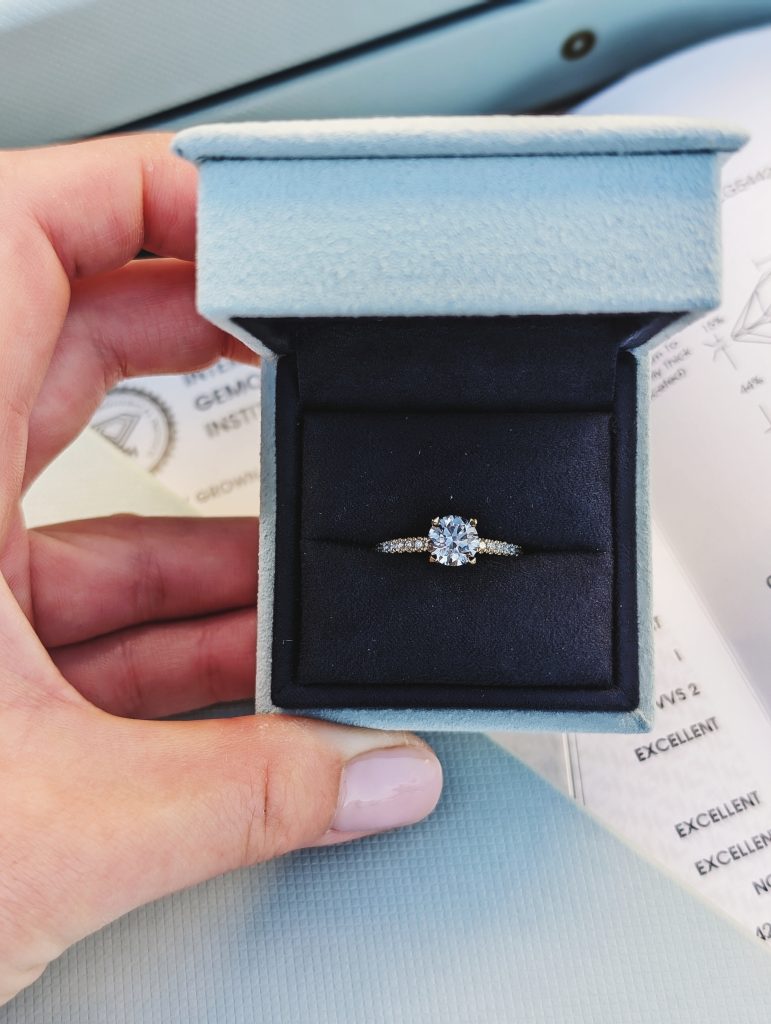 Our round diamond ring in a blue With Clarity presentation box