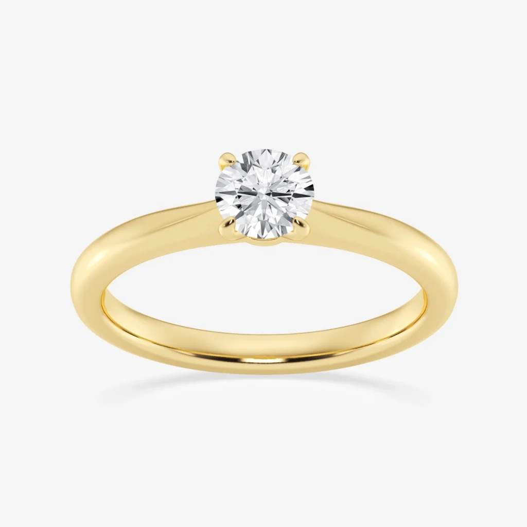 Round diamond in a four-prong yellow-metal solitaire ring