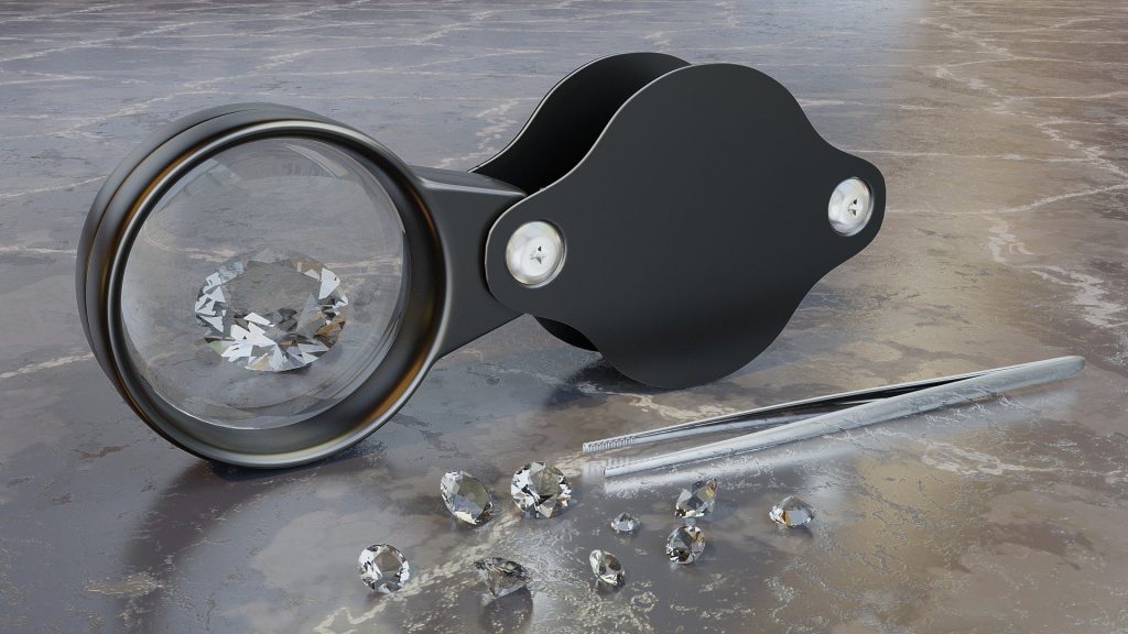 Magnification helps reveal features that may not be visible during everyday wear. A jeweler’s loupe and faceted stones