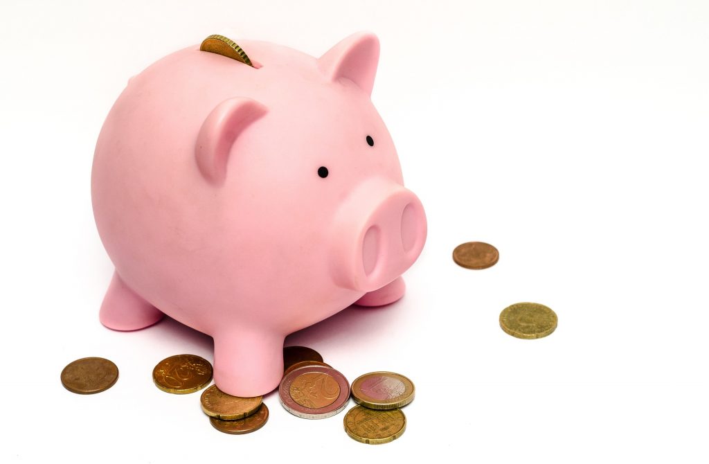 The lower purchase price is a major reason to consider lab-grown diamonds. Piggy bank and coins