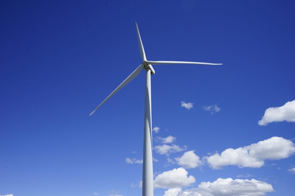 The electricity source matters when comparing diamond production. Wind turbine under a blue sky