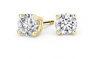 Round diamond studs in simple four-prong yellow-gold basket settings