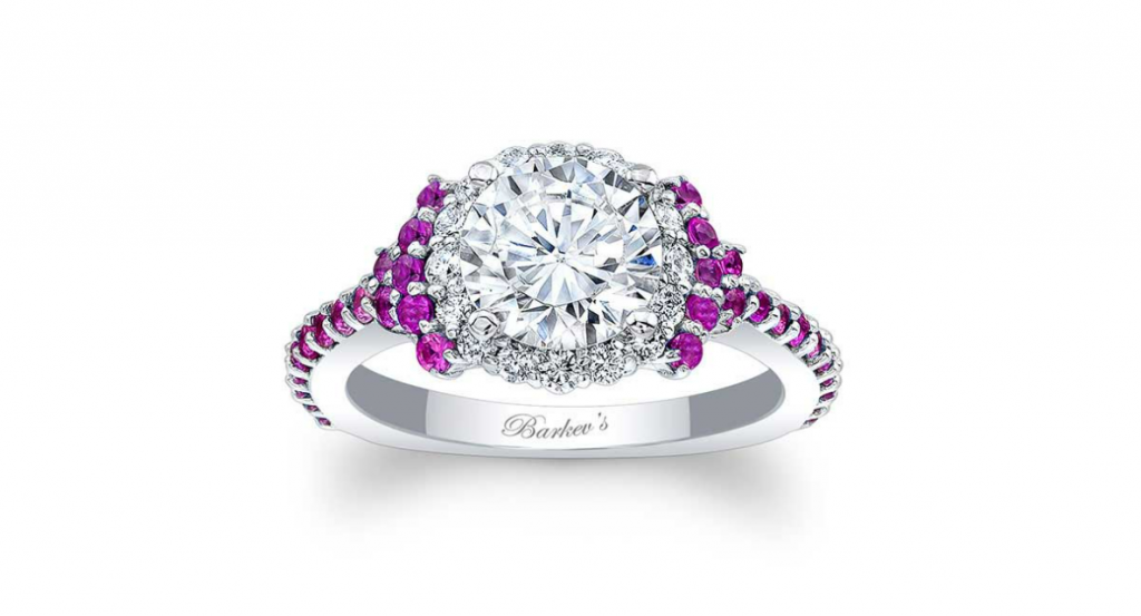 White round center stone framed by white and pink accent stones on a white-metal ring