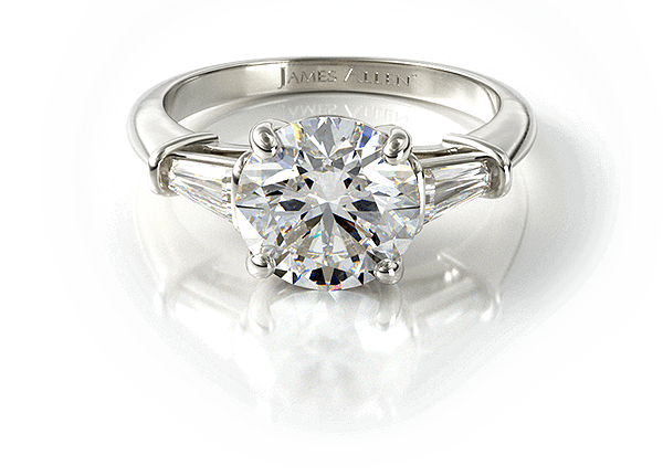 Round diamond ring with tapered baguette side stones in white metal