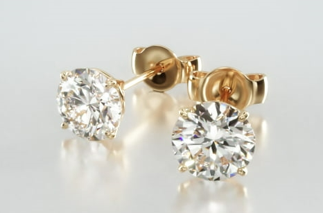 Round diamond stud earrings in yellow-gold four-prong baskets