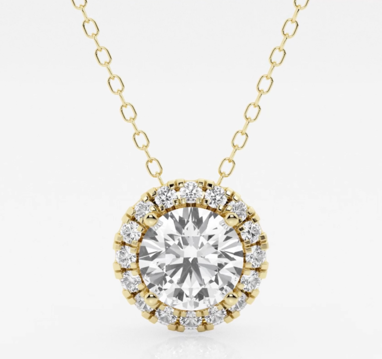 Round diamond pendant inside a halo of smaller diamonds on a yellow-gold chain