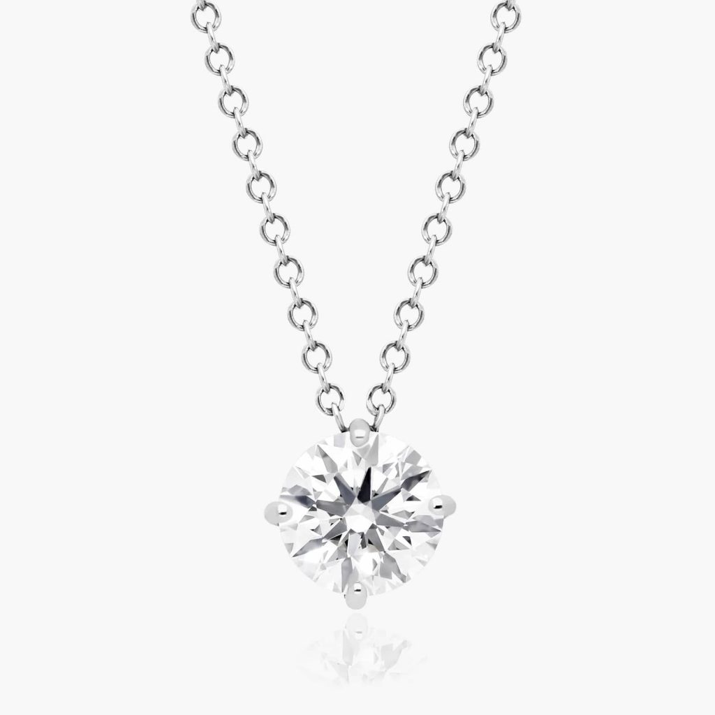 Round diamond in a white-metal four-prong basket on a cable-link chain