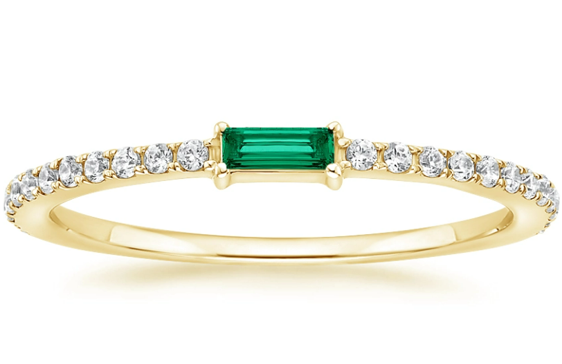 Horizontal baguette-shaped green center on a yellow-gold band with small diamond accents