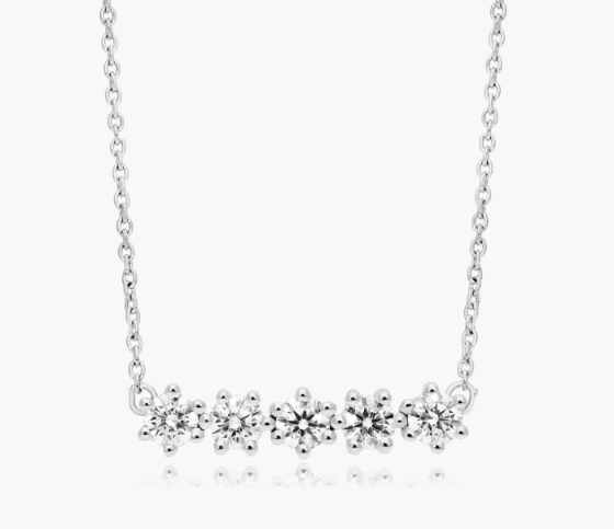 Five graduated round diamonds in a short horizontal row on a white-metal chain
