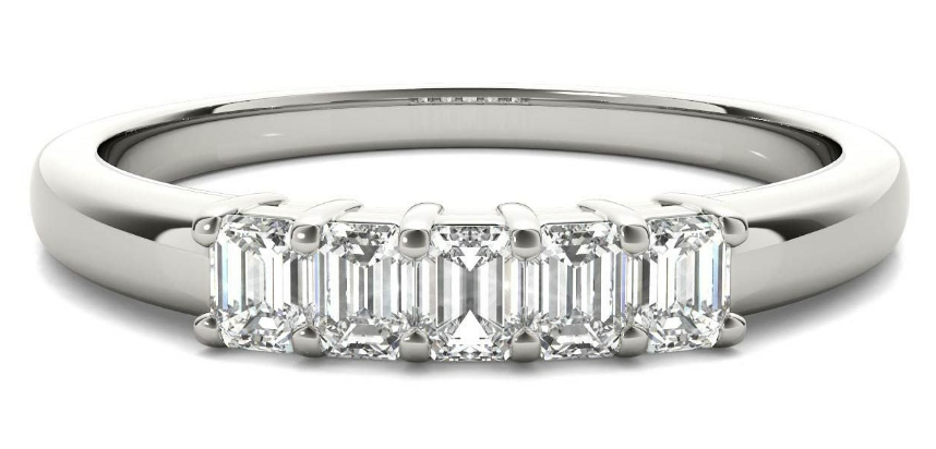 Five emerald-cut diamonds in white-metal prong settings across the top of a ring