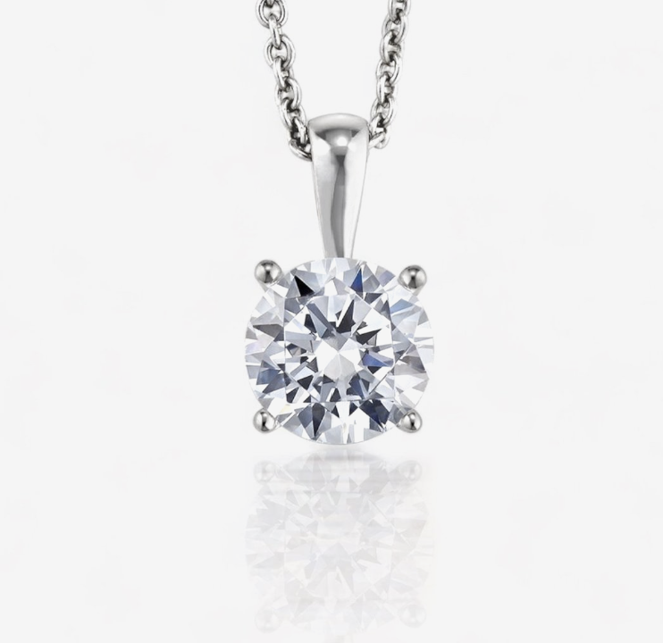 Single round diamond in four white-metal prongs below a polished pendant bail