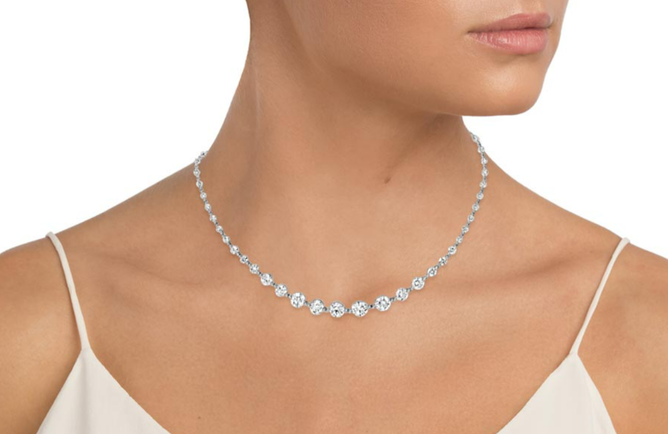 Graduated diamond necklace worn at the base of the neck
