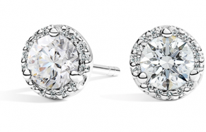 Round diamond centers surrounded by smaller white-metal halo diamonds