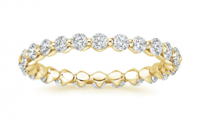 Yellow-gold eternity band with round diamonds in shared-prong settings