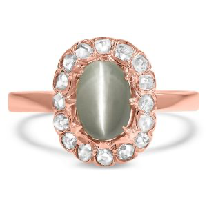 A cat's eye chrysoberyl cabochon surrounded by a halo of rose-cut diamonds in a Victorian-era ring from Brilliant Earth