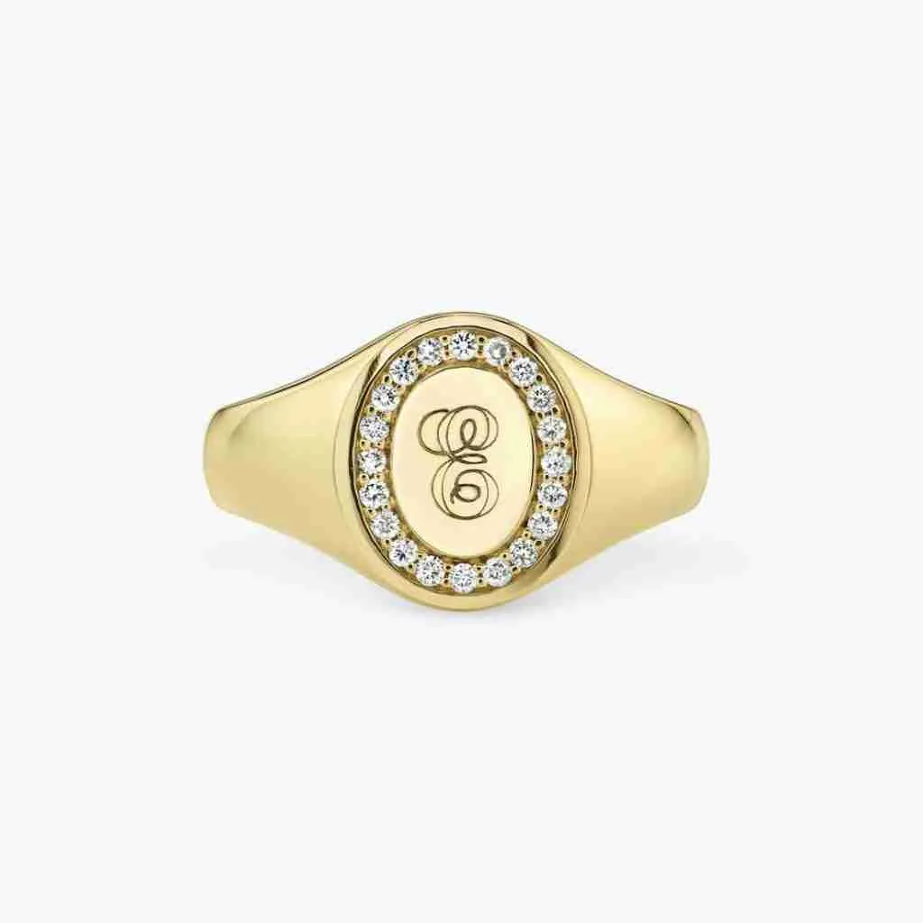 Yellow-gold oval signet ring with an engraved initial and small diamonds around its edge