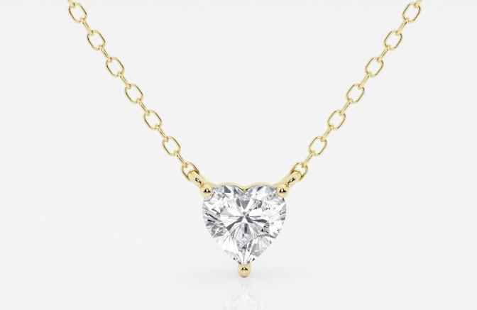 Heart-cut diamond in a yellow-gold three-prong pendant