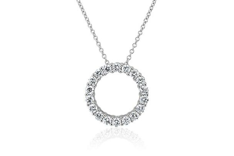 Open circle pendant outlined with round diamonds on a white-metal chain