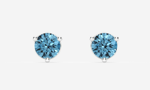 Two round blue diamond stud earrings in white-metal prong settings