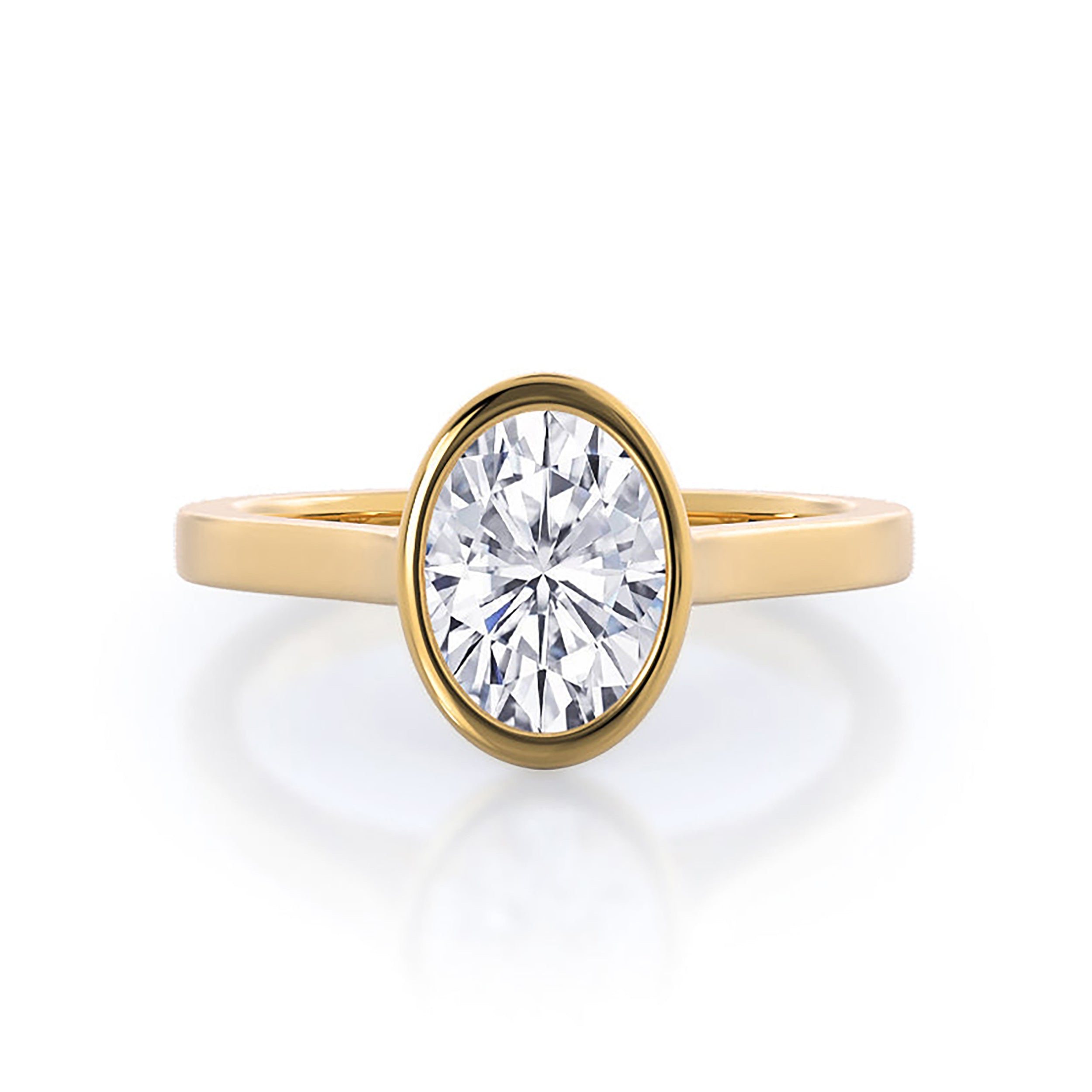 Oval bezel-set lab-grown diamond engagement ring in yellow gold