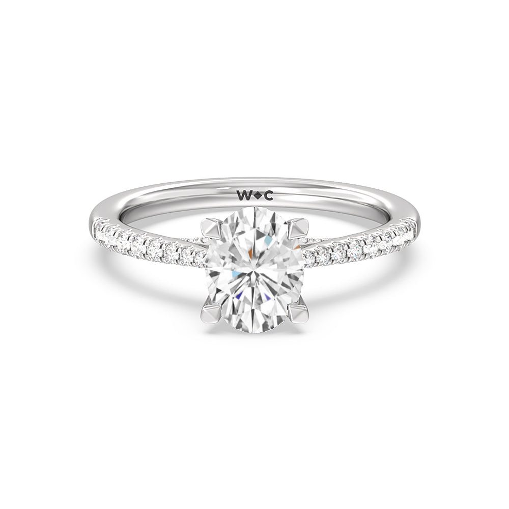 Oval lab-grown diamond engagement ring with a pavé band and hidden halo