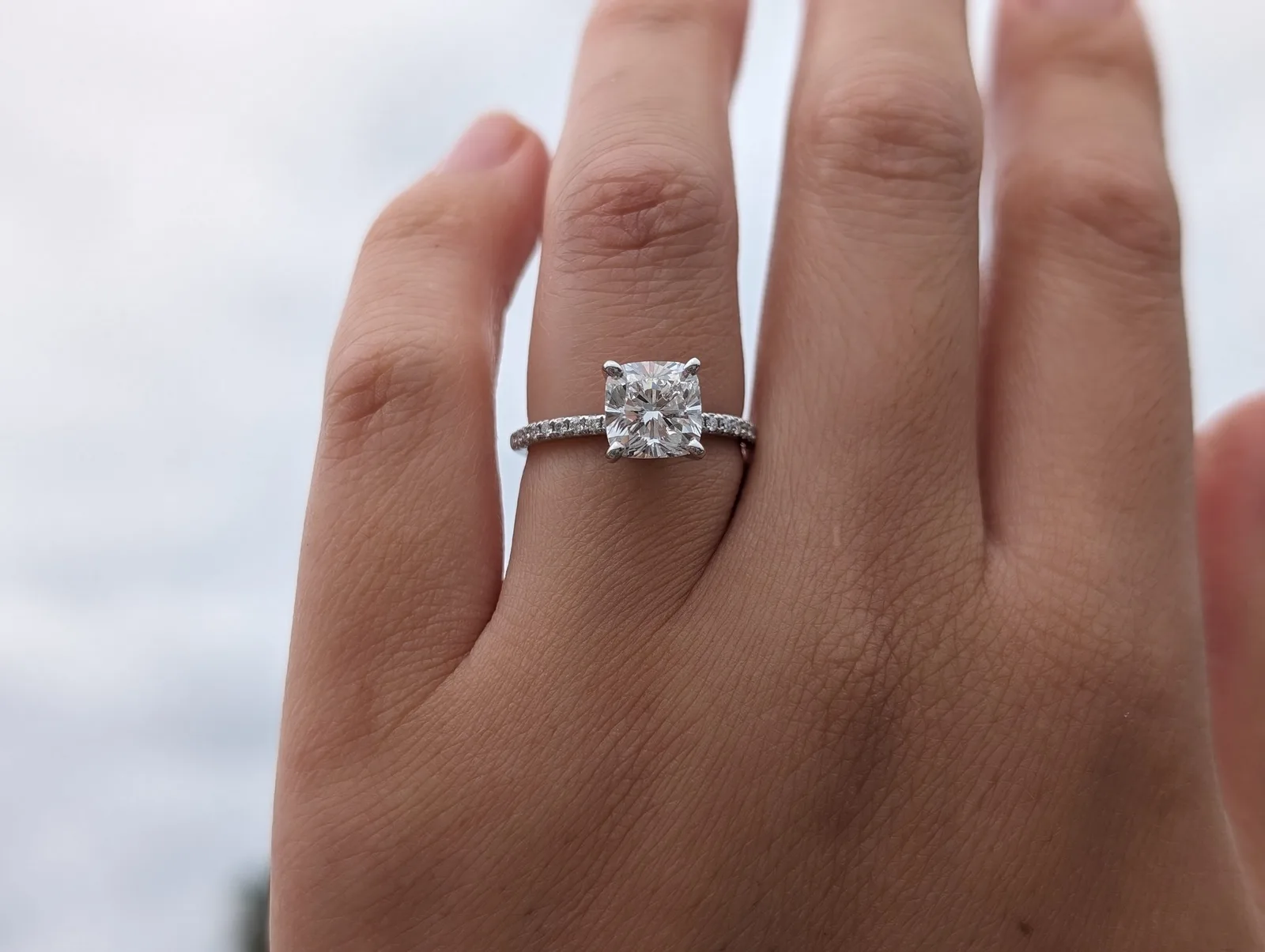 The 1.85-carat cushion-cut lab-grown diamond ring we bought from Blue Nile. Blue Nile cushion-cut lab-grown diamond engagement ring worn on a hand