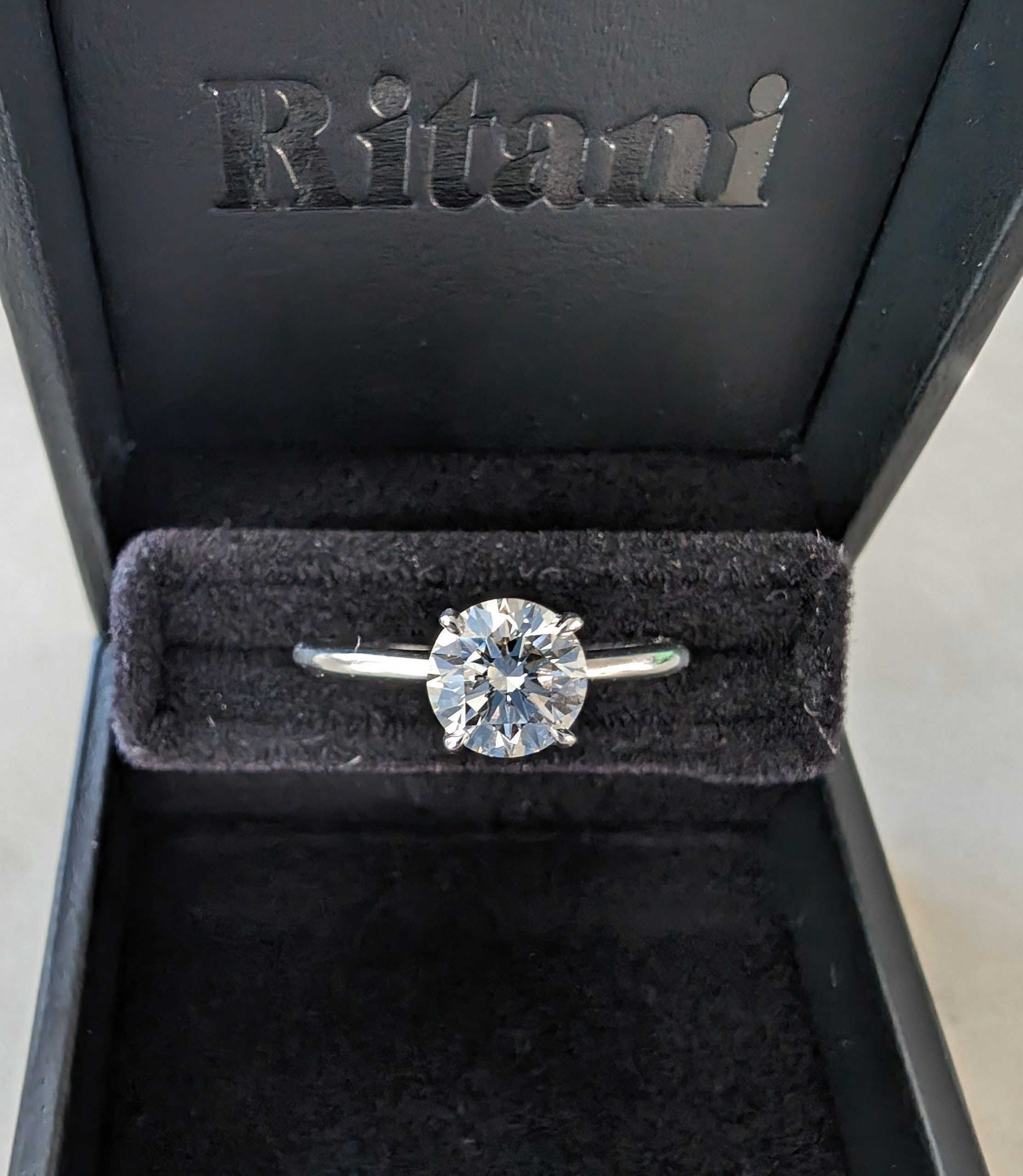 Round lab-grown diamond ring in a black Ritani box