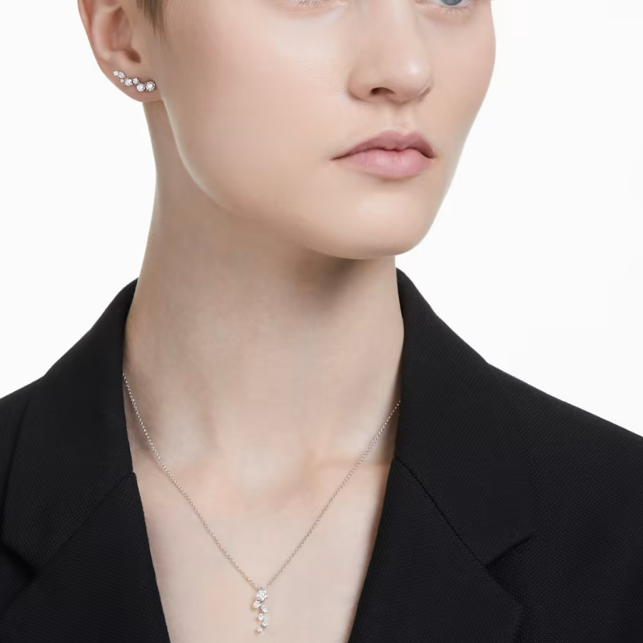 Swarovski diamond ear climbers and a drop pendant worn together