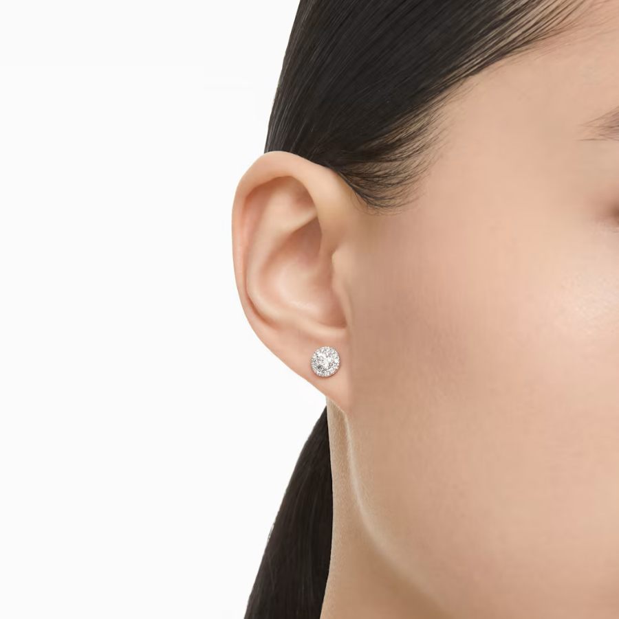 Small Swarovski halo diamond stud worn on an ear