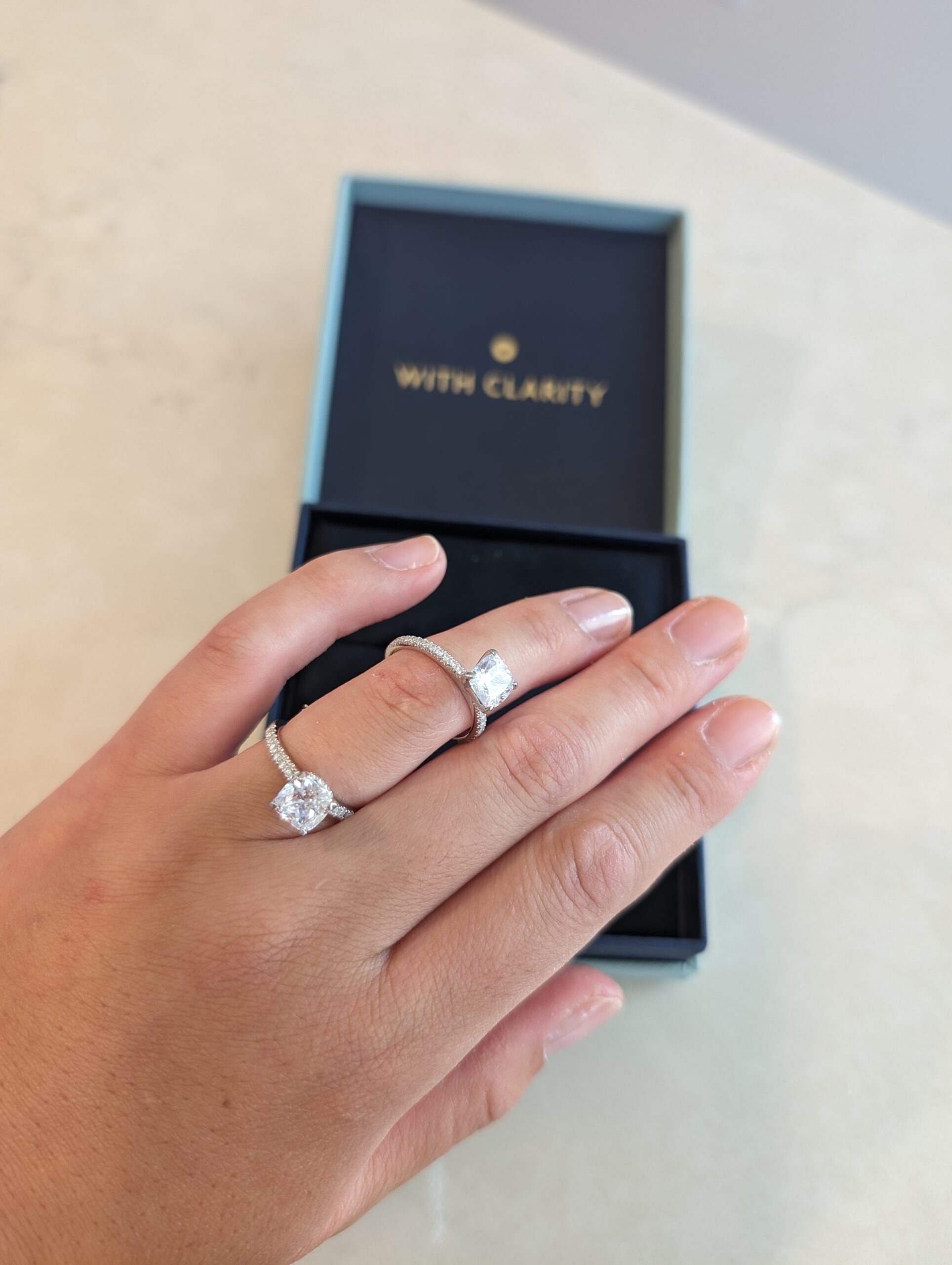 The two replica engagement-ring designs from our Home Preview test. Two With Clarity Home Preview rings on hand