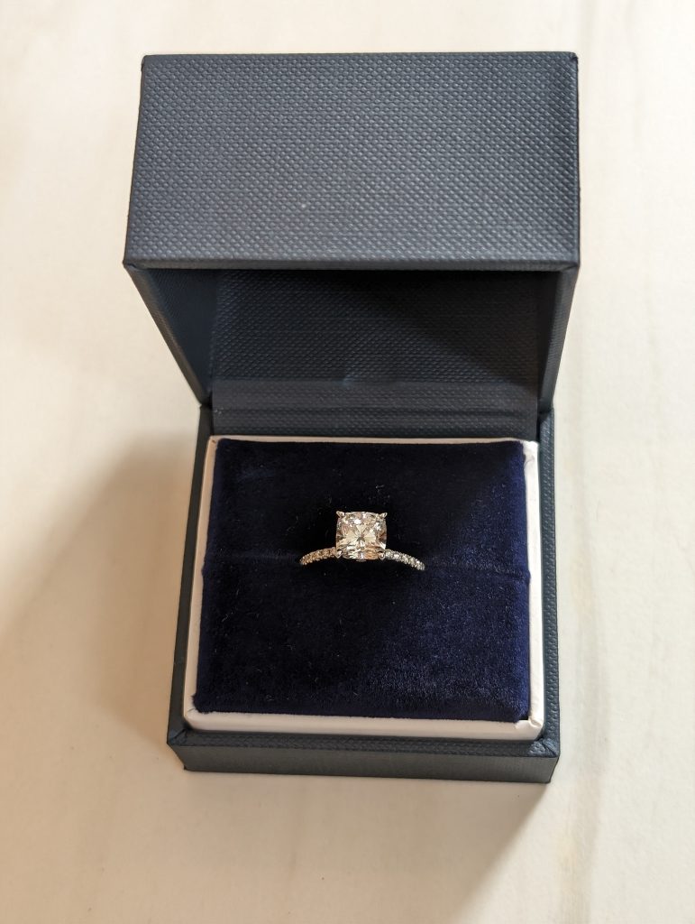 1.85 carat cushion cut lab-grown diamond engagement ring in original presentation box.